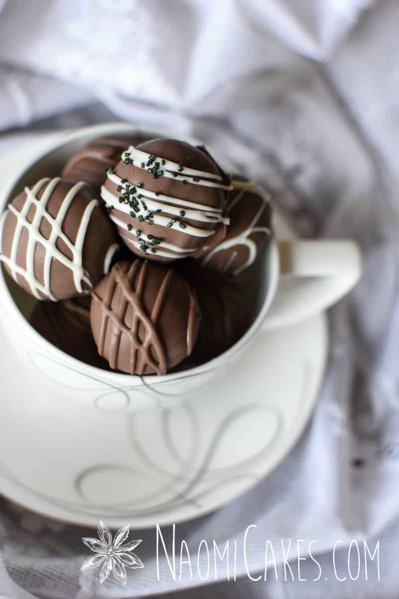 chocolate truffles inside of a white and silver tea cup