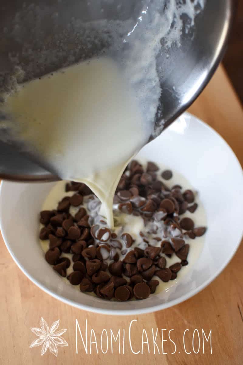cream pouring from a pot into a bowl with chocolate chips