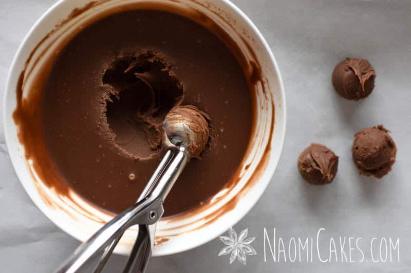 scooping milk chocolate ganache out of a bowl for truffles