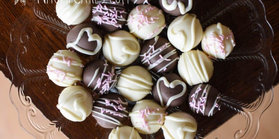 plate of assorted homemade white chocolate truffles on a wooden table