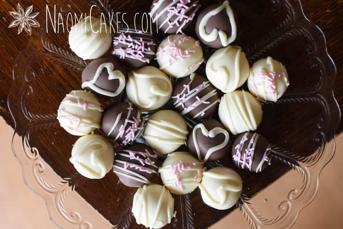 plate of assorted homemade white chocolate truffles on a wooden table