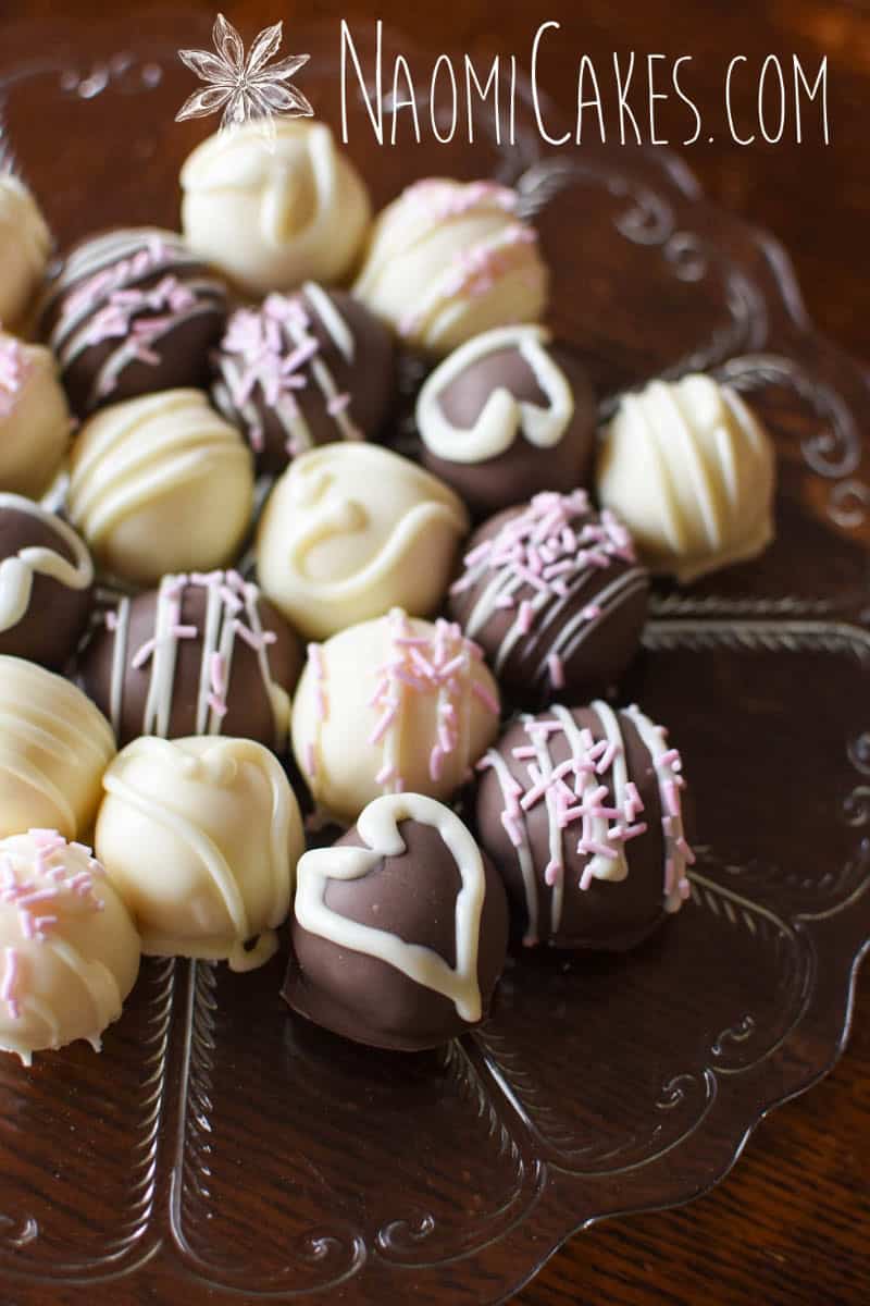 plate of assorted homemade white chocolate truffles on a wooden table