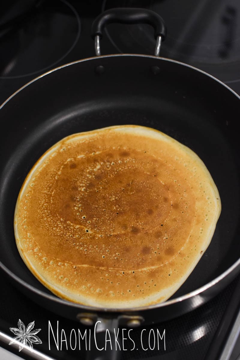 fried crepe in a non stick pan on an electric stovetop