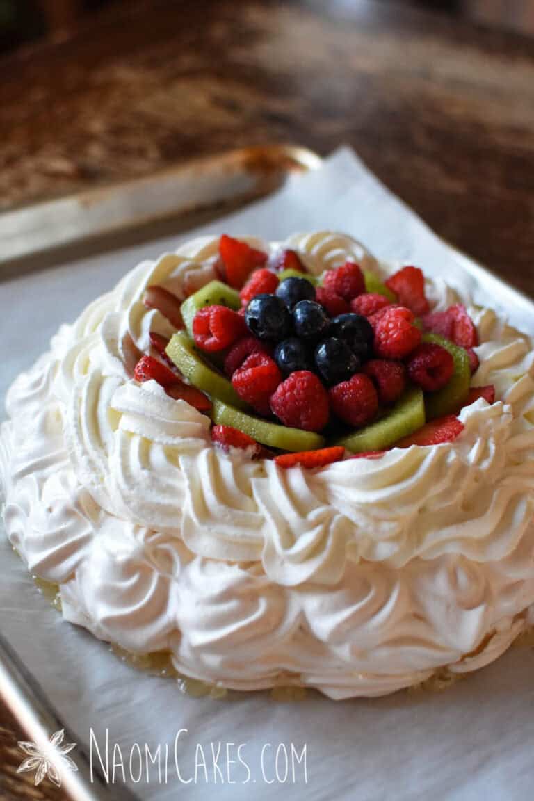 creamy custard pavlova with fruit and berries