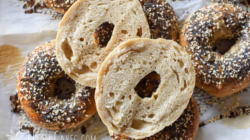 a cut open everything bagel on top of whole bagels