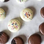assorted chocolate and white chocolate covered or dipped Oreos on parchment