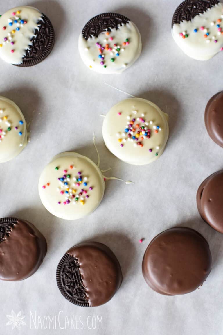 assorted chocolate and white chocolate covered or dipped Oreos on parchment