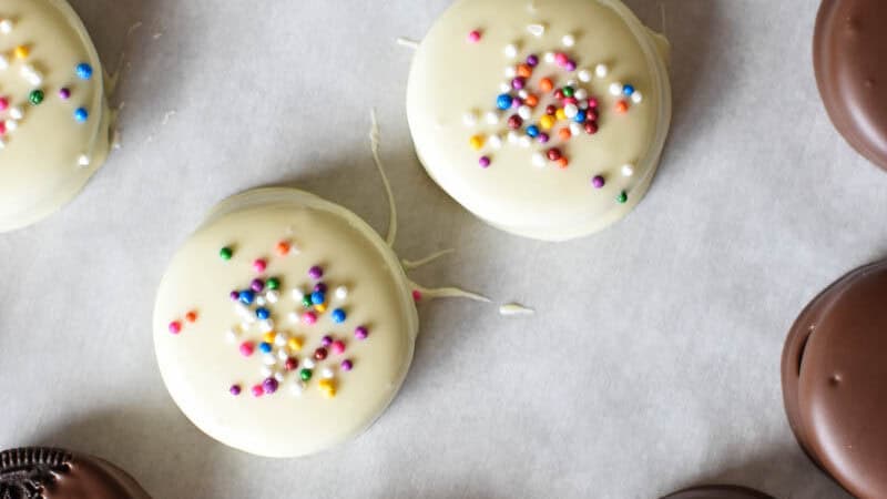 assorted chocolate and white chocolate covered or dipped Oreos on parchment