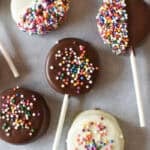 oreo lollipops with sprinkles on parchment