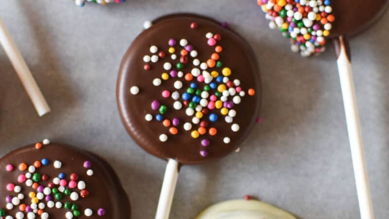 oreo lollipops with sprinkles on parchment