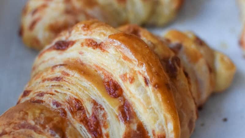 Cheesy croissants on a baking sheet