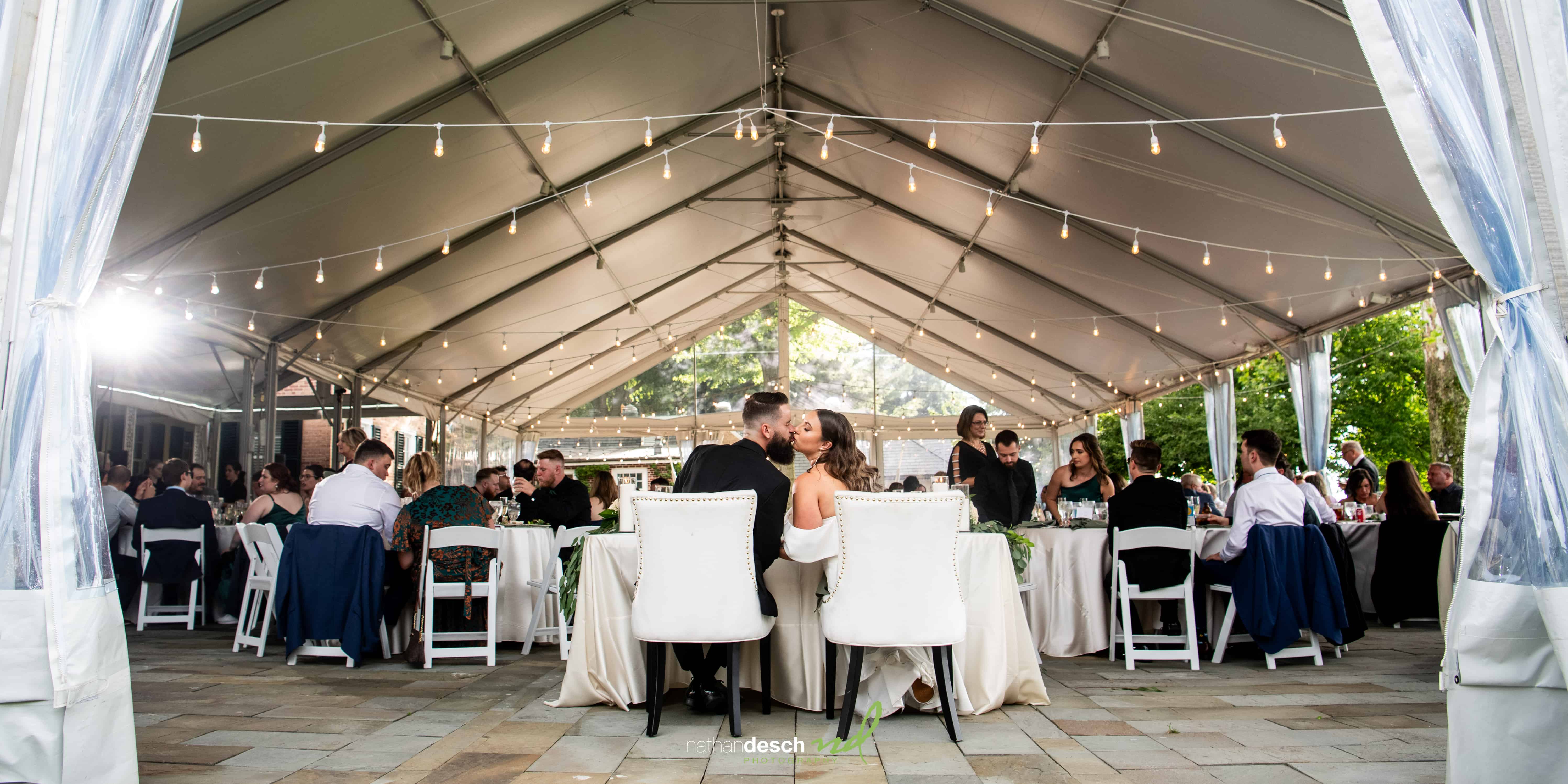 Bride and groom share kiss at their reception