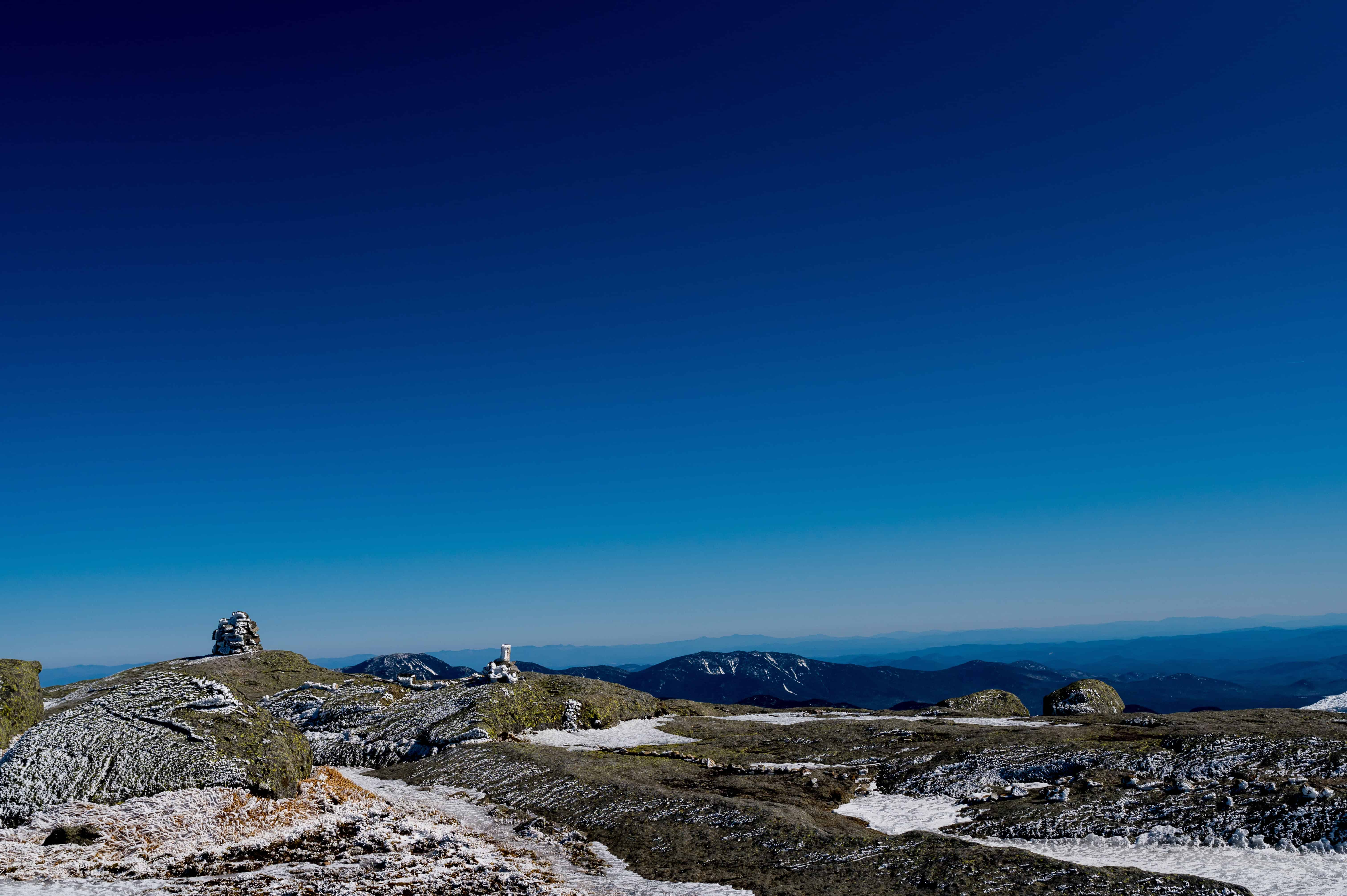 Scenic White Mountains with snowy patches, rocky green terrain, and open skies—ideal for adventure elopement wedding photos.