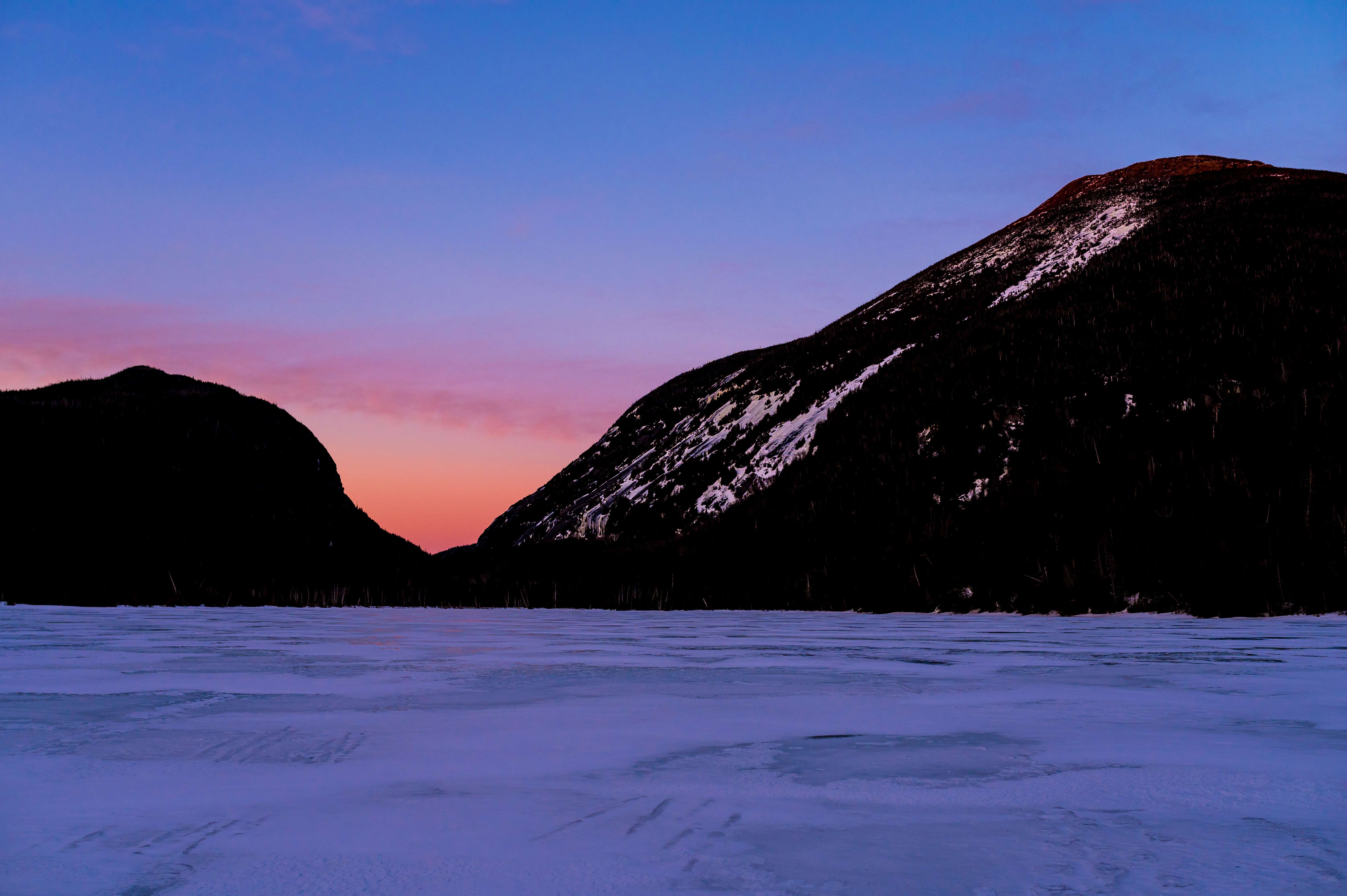 Stunning White Mountains sunset elopement with snow peaks and frozen lake, perfect for adventurous winter weddings.