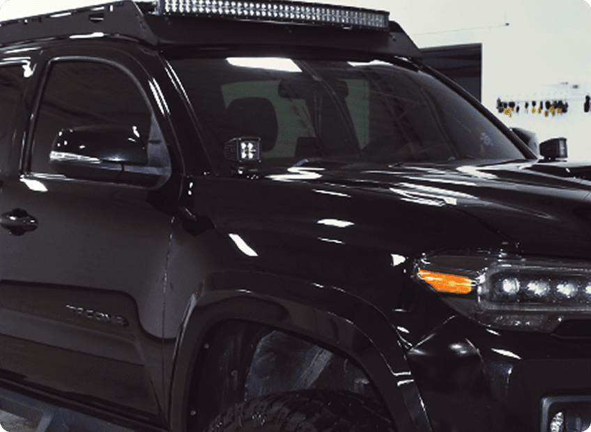 A black truck with lights on top.