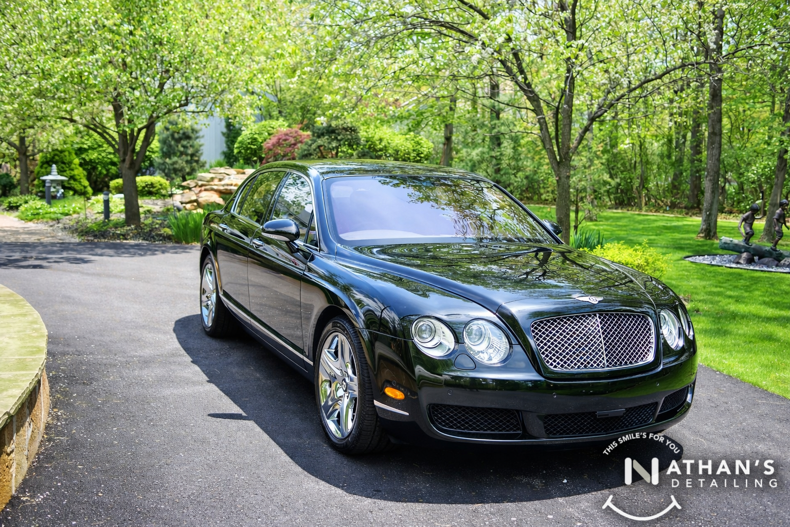 Bentley sedan glossy front three quarter view during mobile detailing