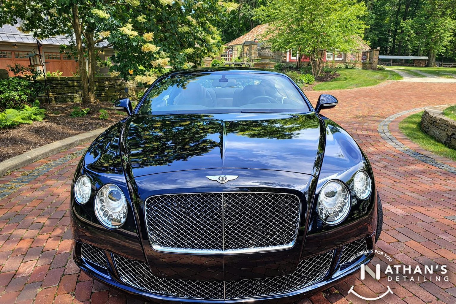Black bentley front view glossy finish during mobile detailing