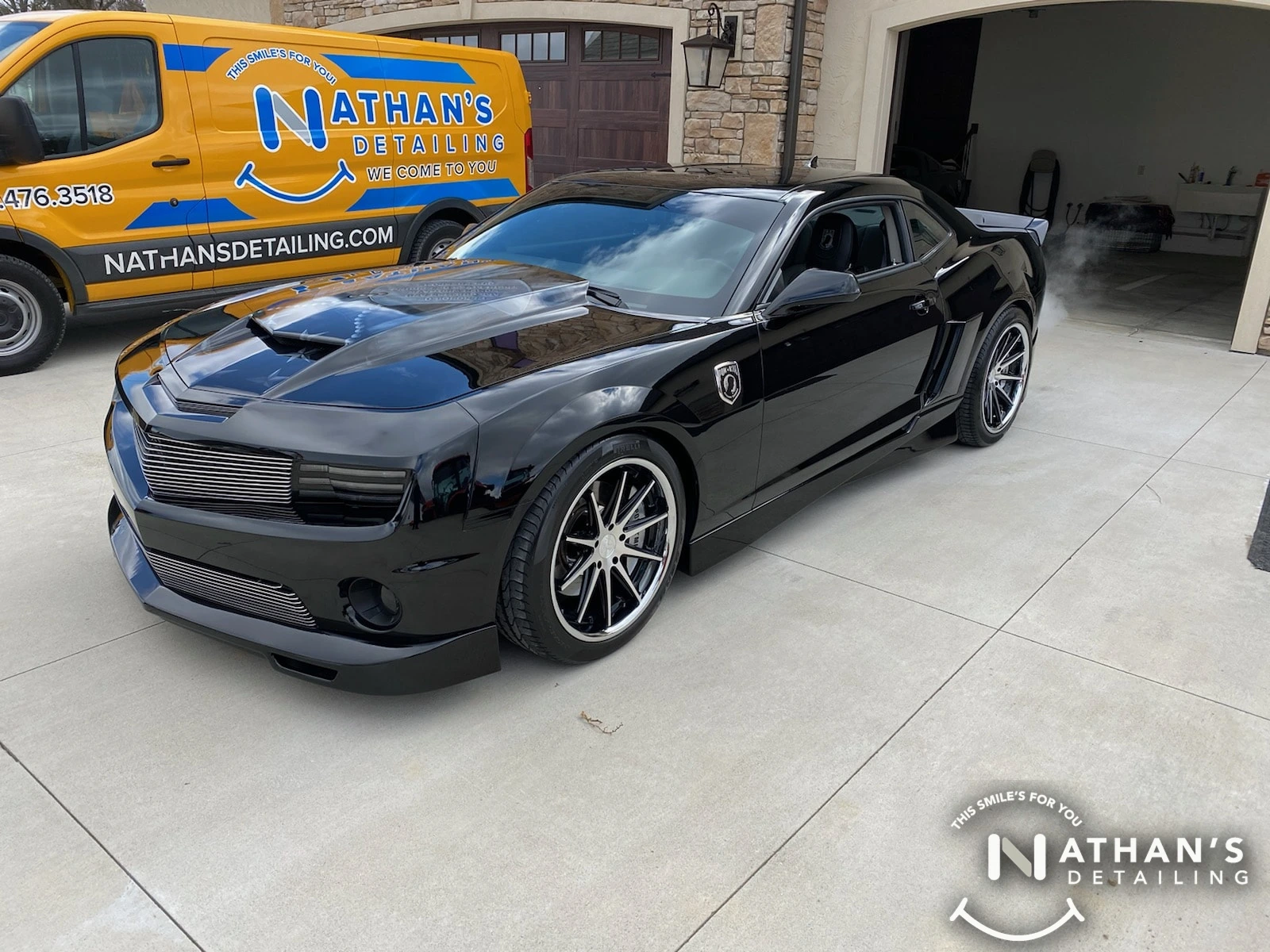 Deep gloss and mirror reflection on a black car after a professional mobile paint correction.