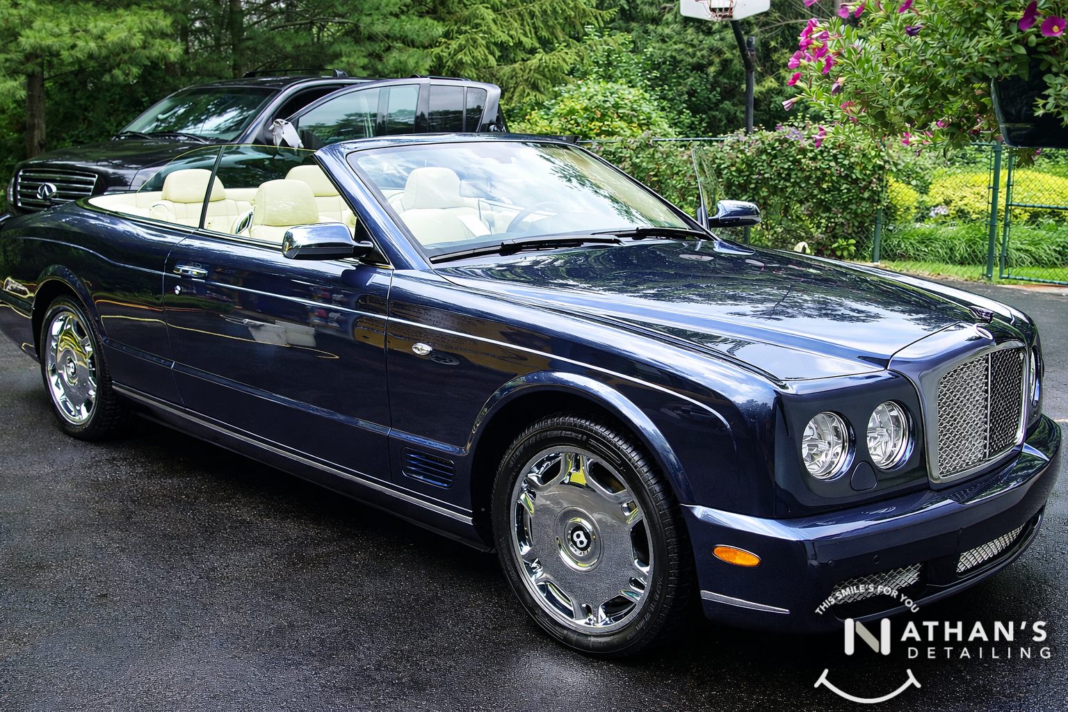Black convertible glossy finish driveway during mobile detailing