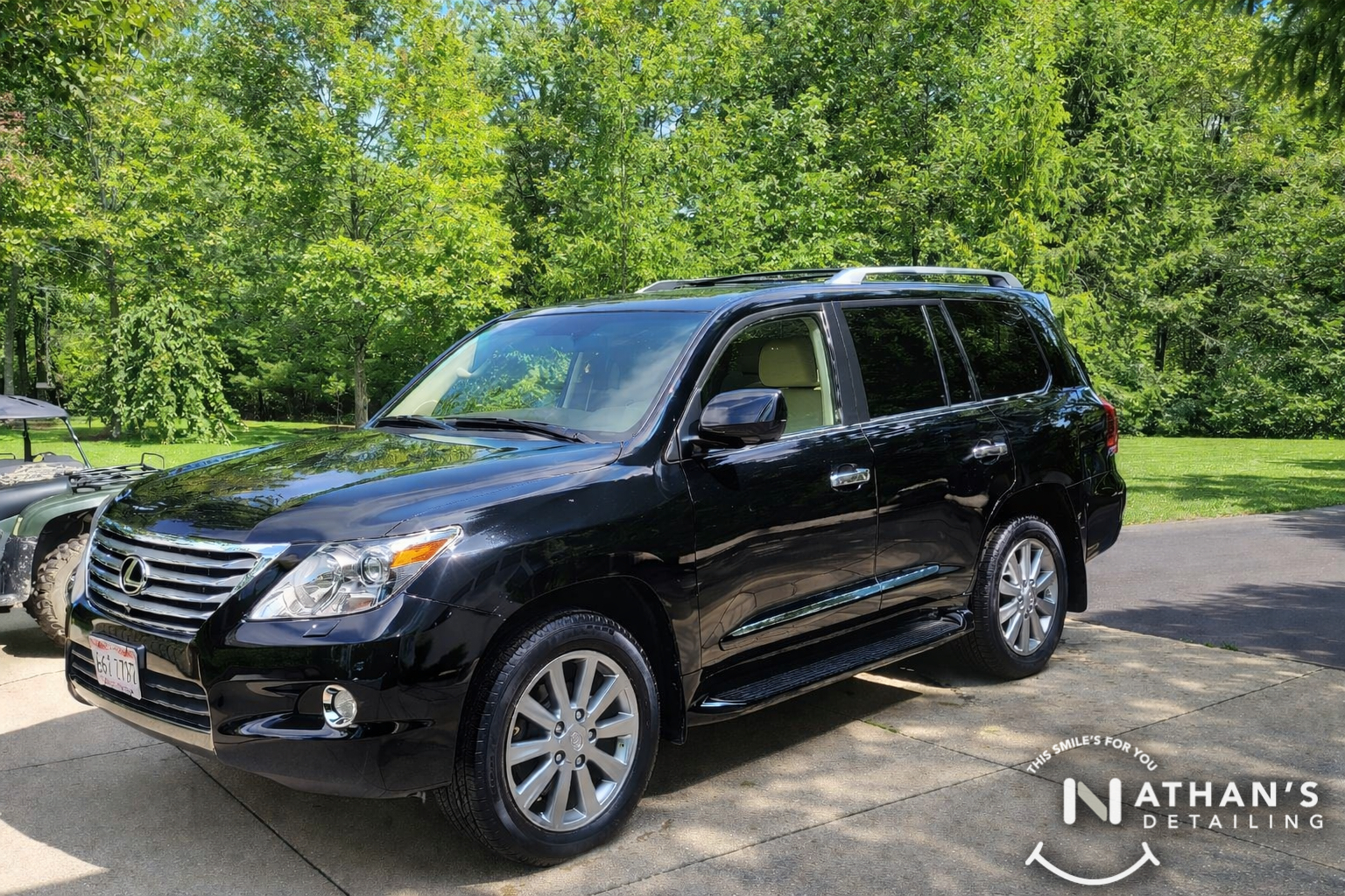 Black lexus suv glossy driveway finish during mobile detailing