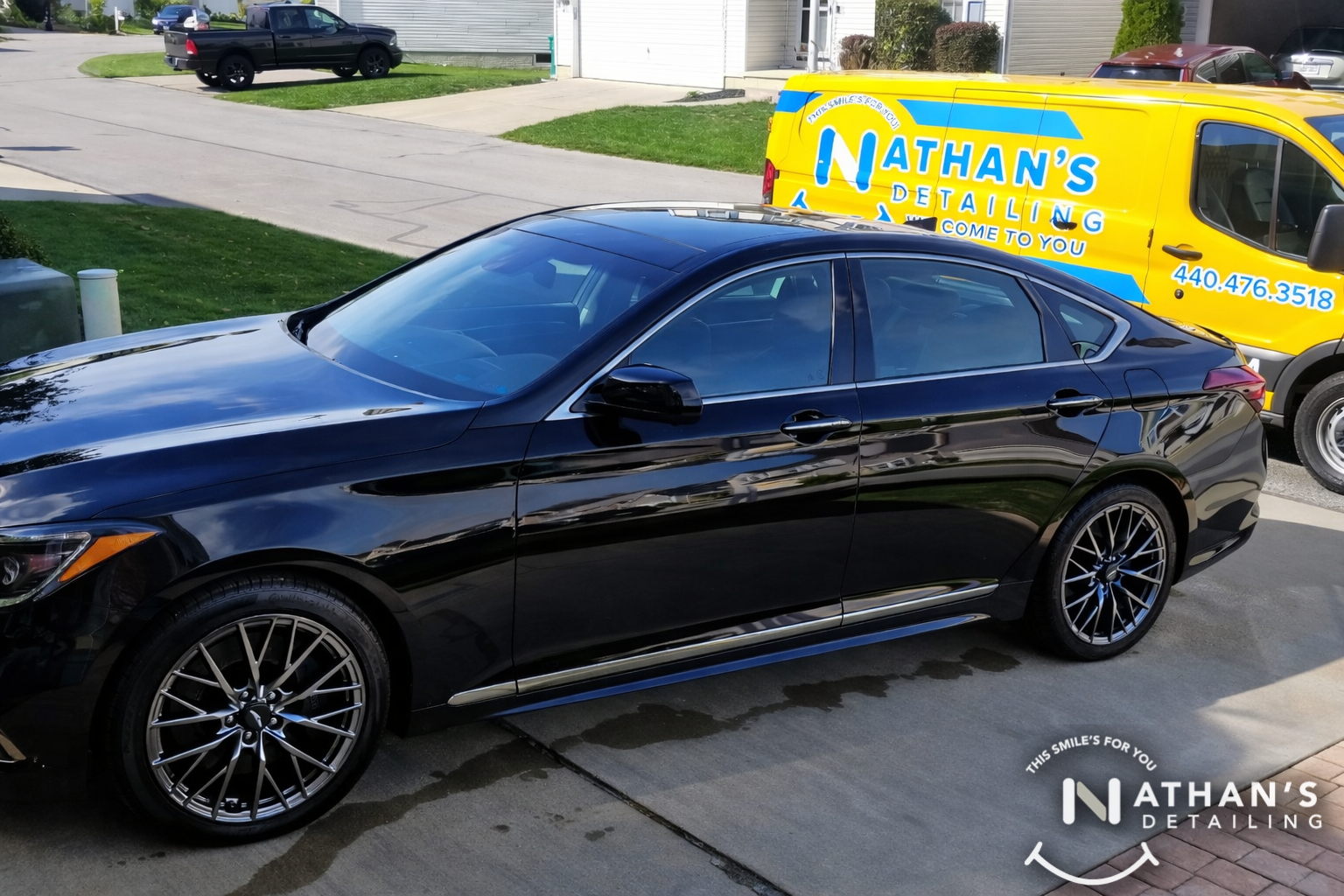 Black sedan cleaned with mobile van during mobile detailing