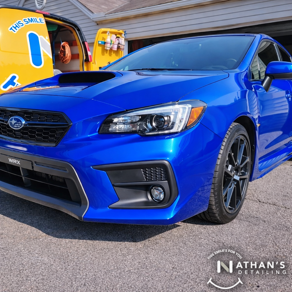 Blue sport sedan polished front corner during mobile detailing