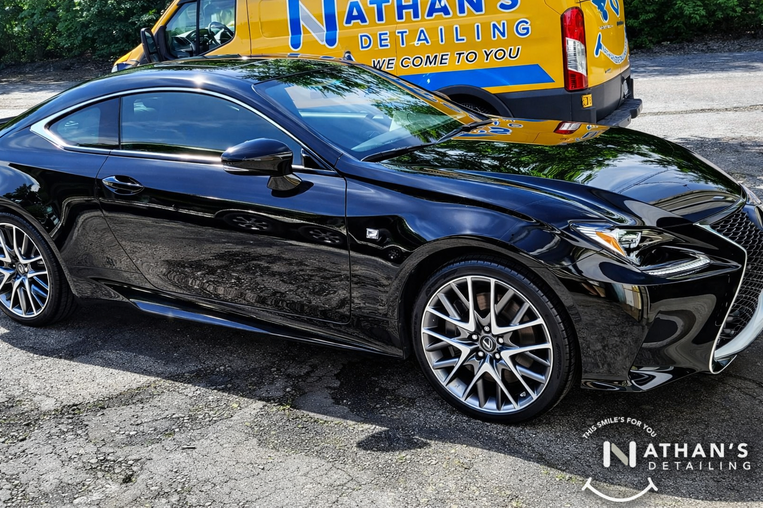 Glossy black coupe with detailing van during mobile detailing