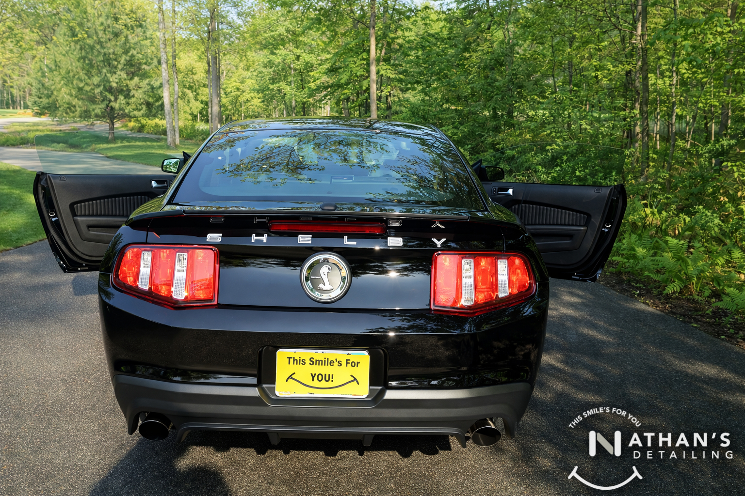 Glossy mustang rear view doors open during mobile detailing