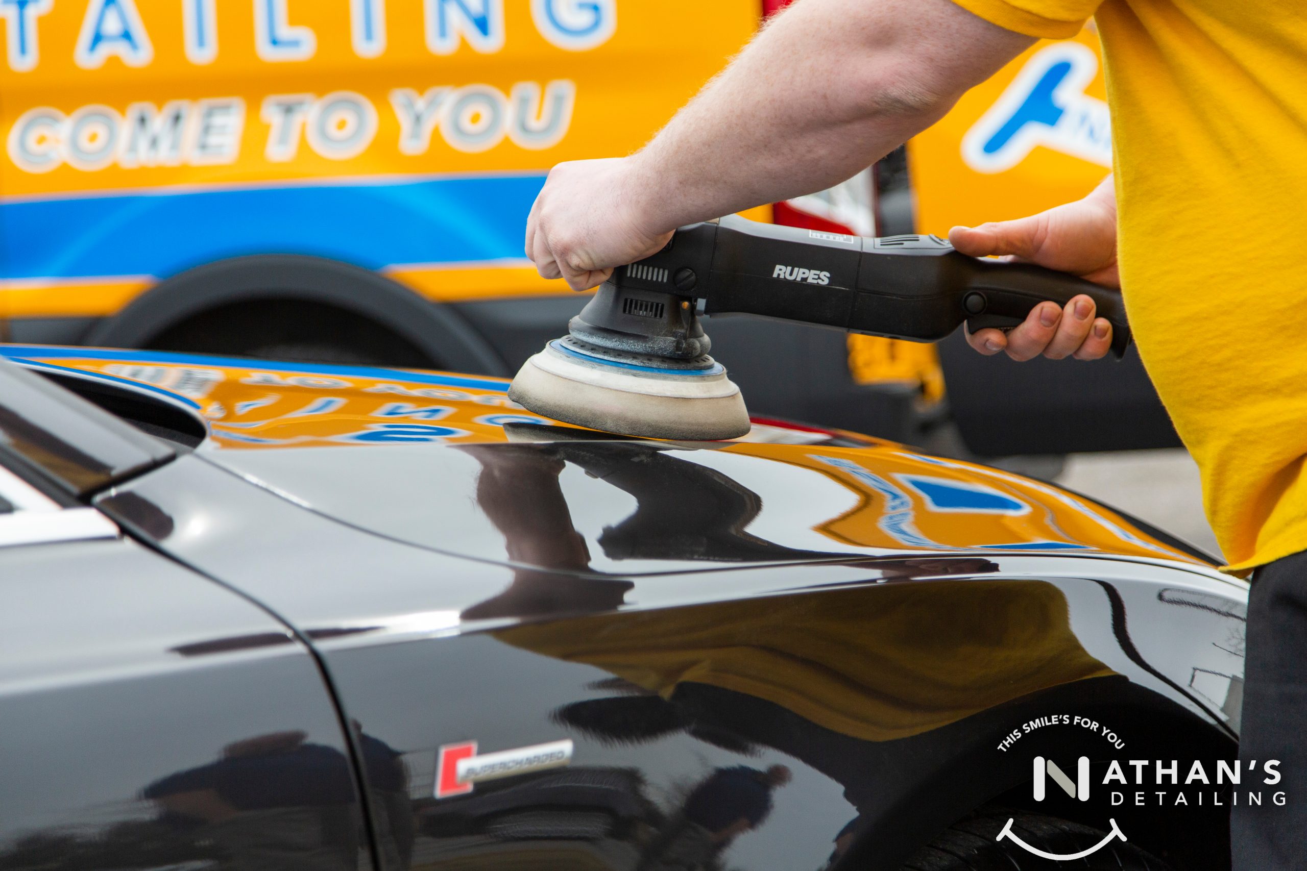 Machine polish glossy black panel during mobile detailing in Canton