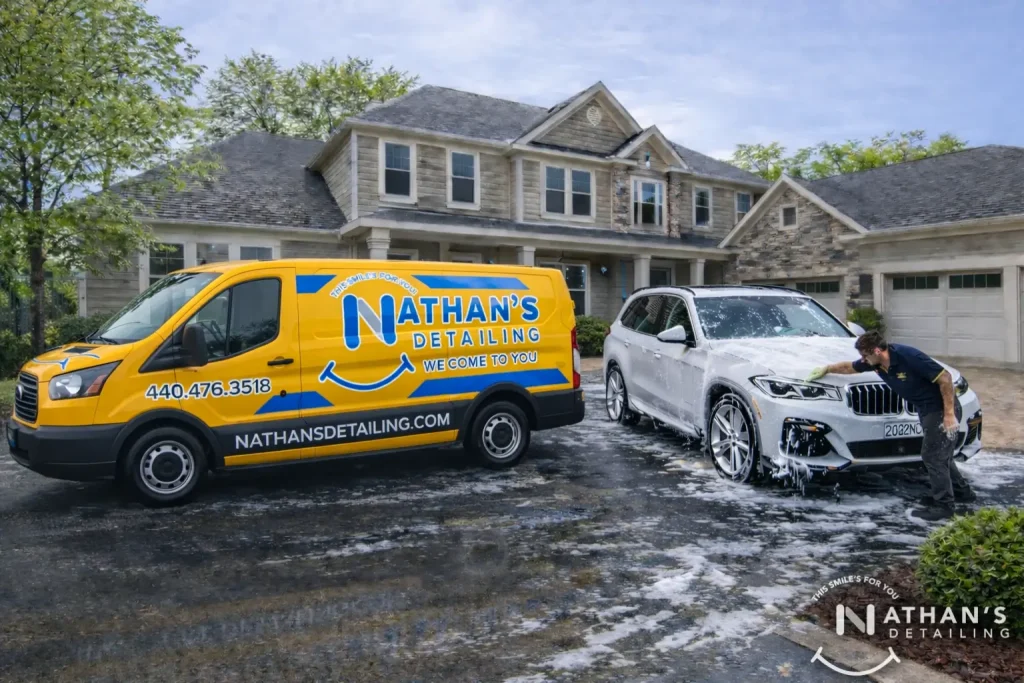 Mobile detailing car wash being performed in a customer’s driveway at home.