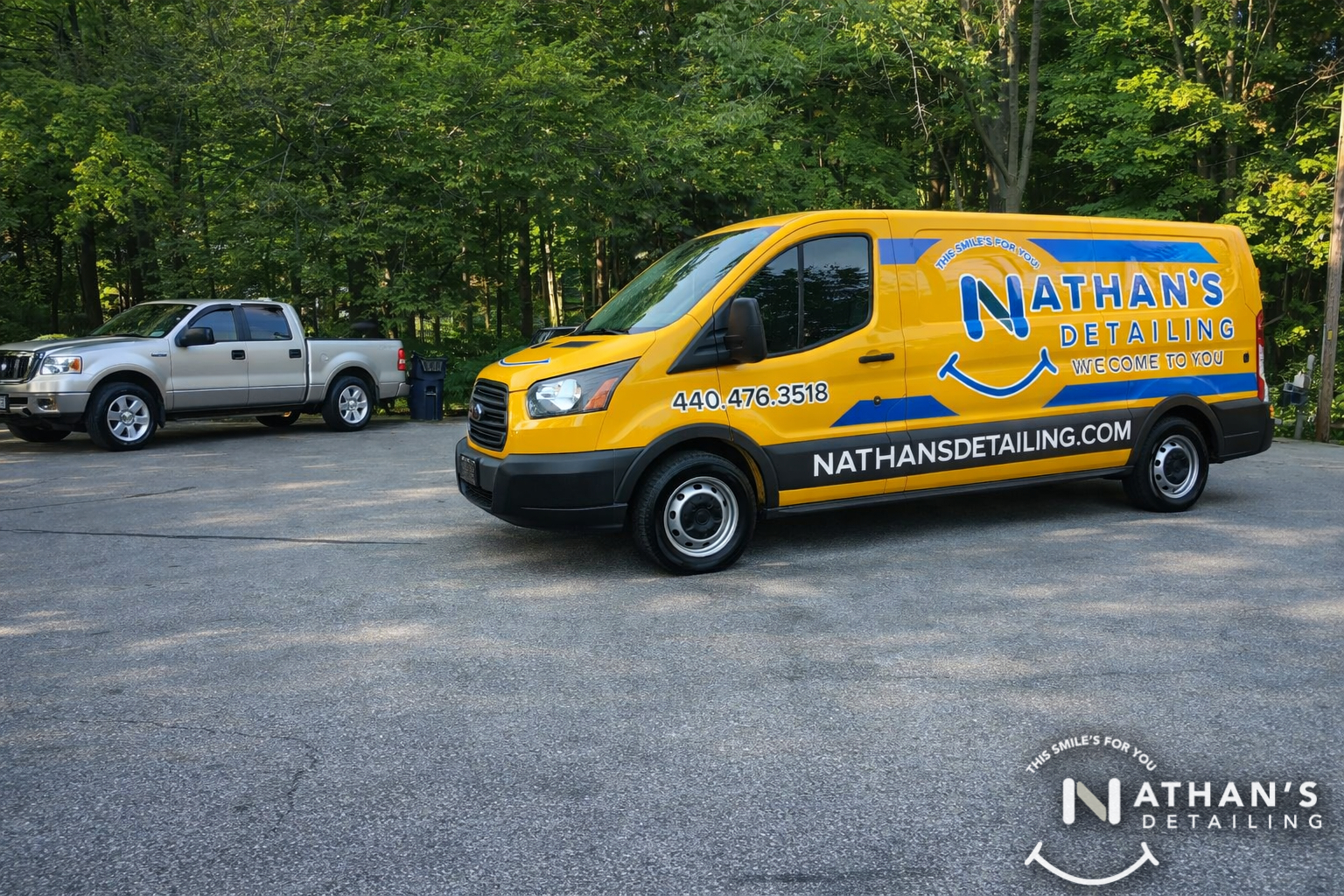 Mobile detailing van parked by trees