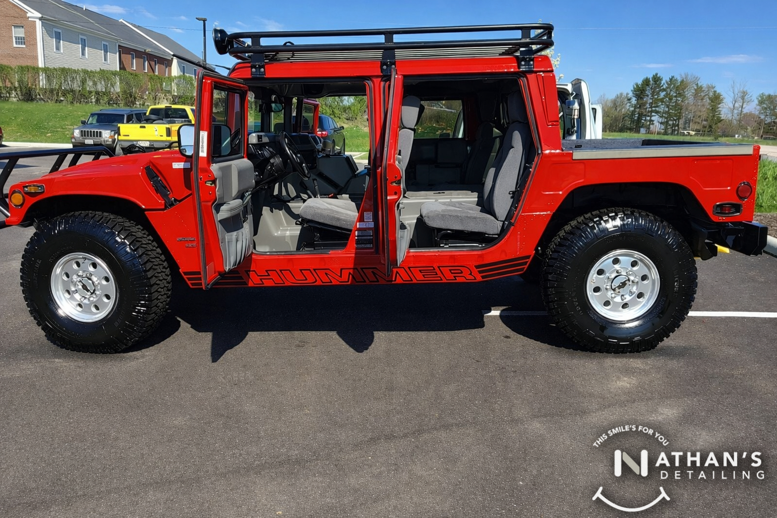 Red hummer open doors clean interior during mobile detailing