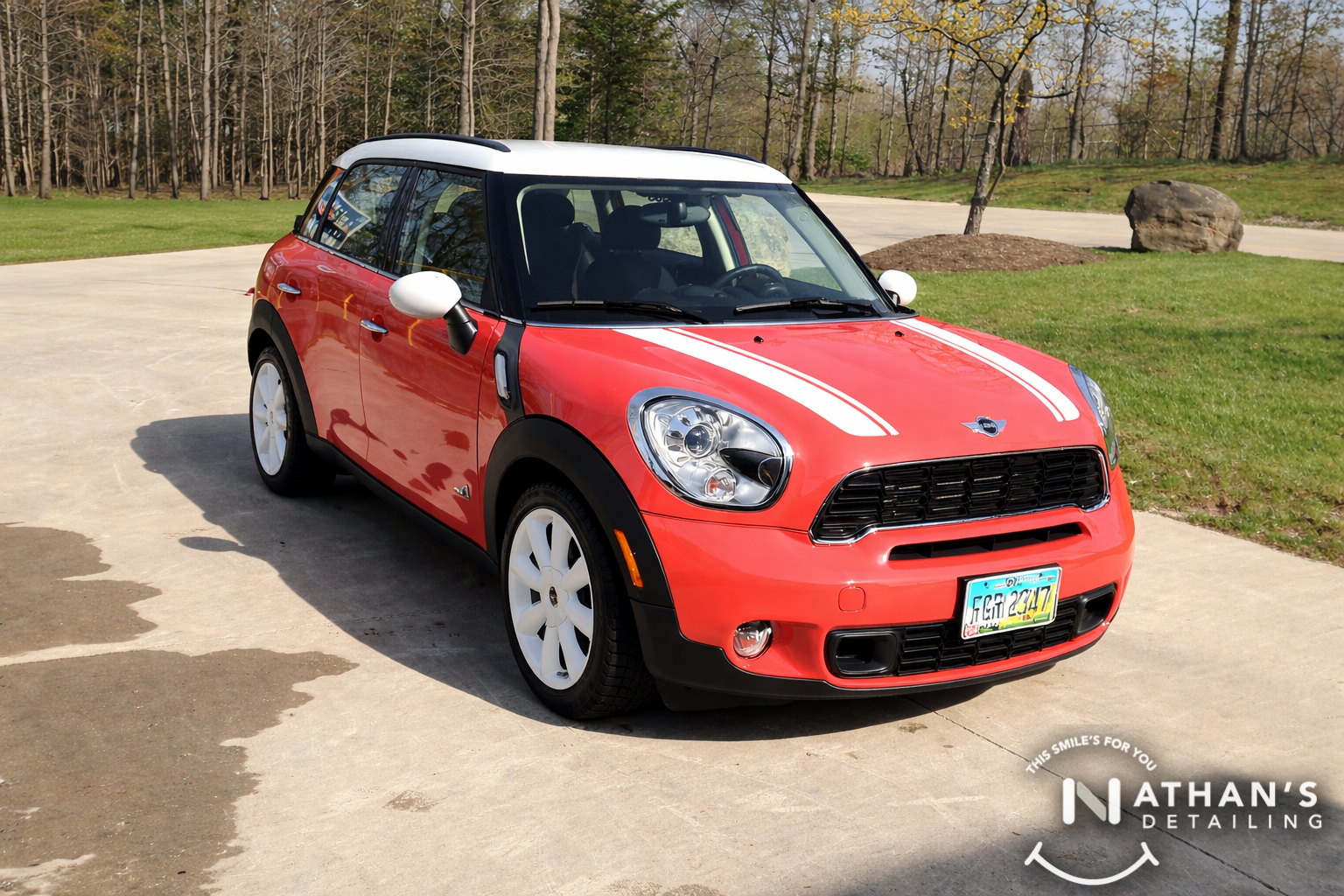 Red mini cooper cleaned in driveway during mobile detailing