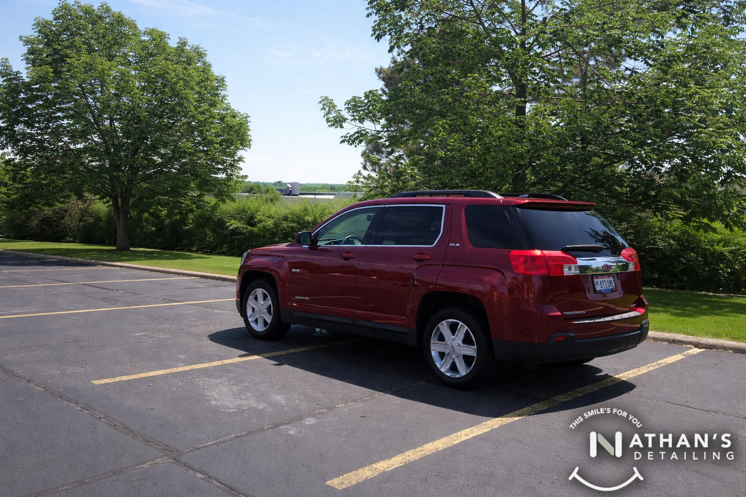 Red suv cleaned in parking lot during mobile detailing