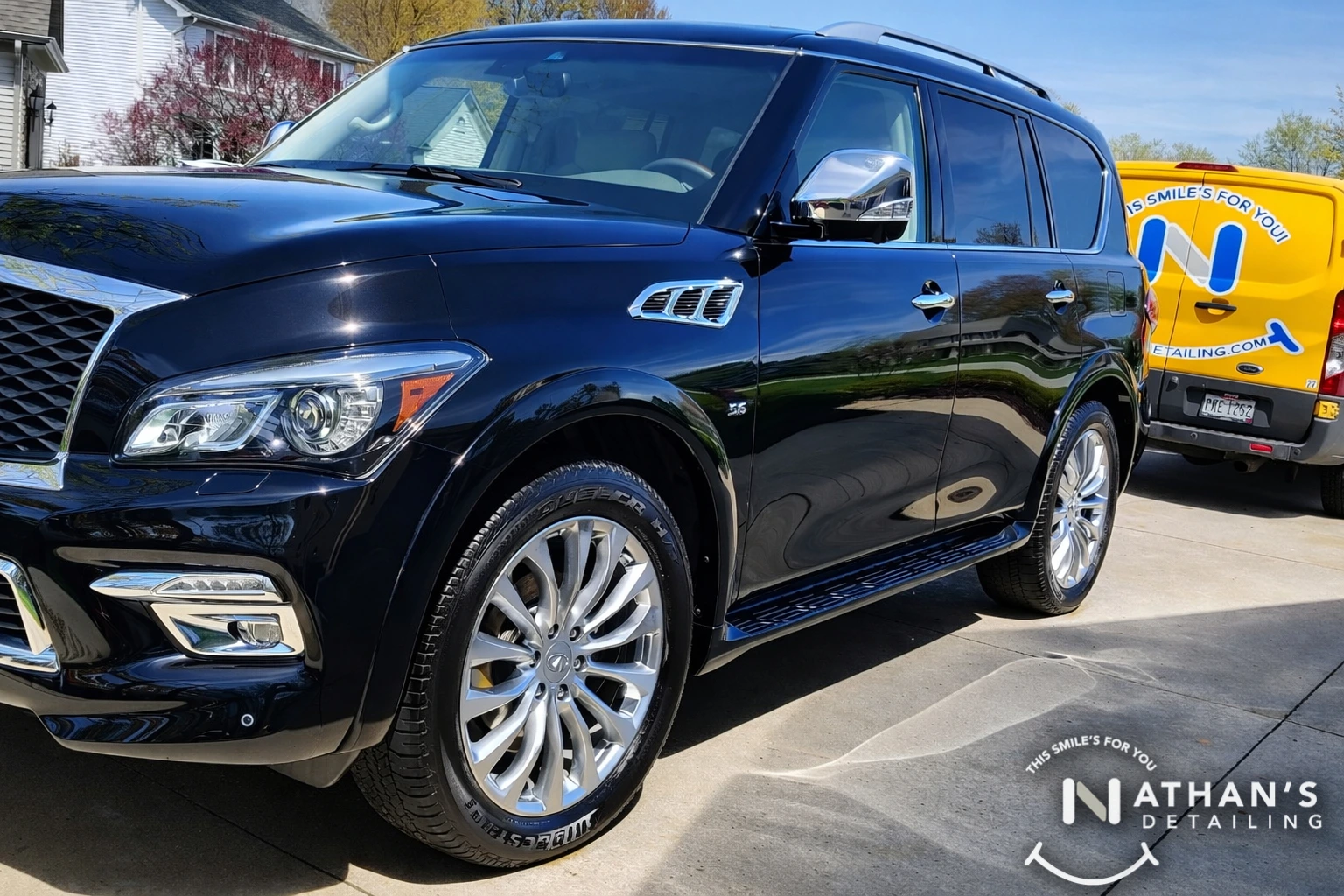 Shiny black suv after driveway detail during mobile detailing