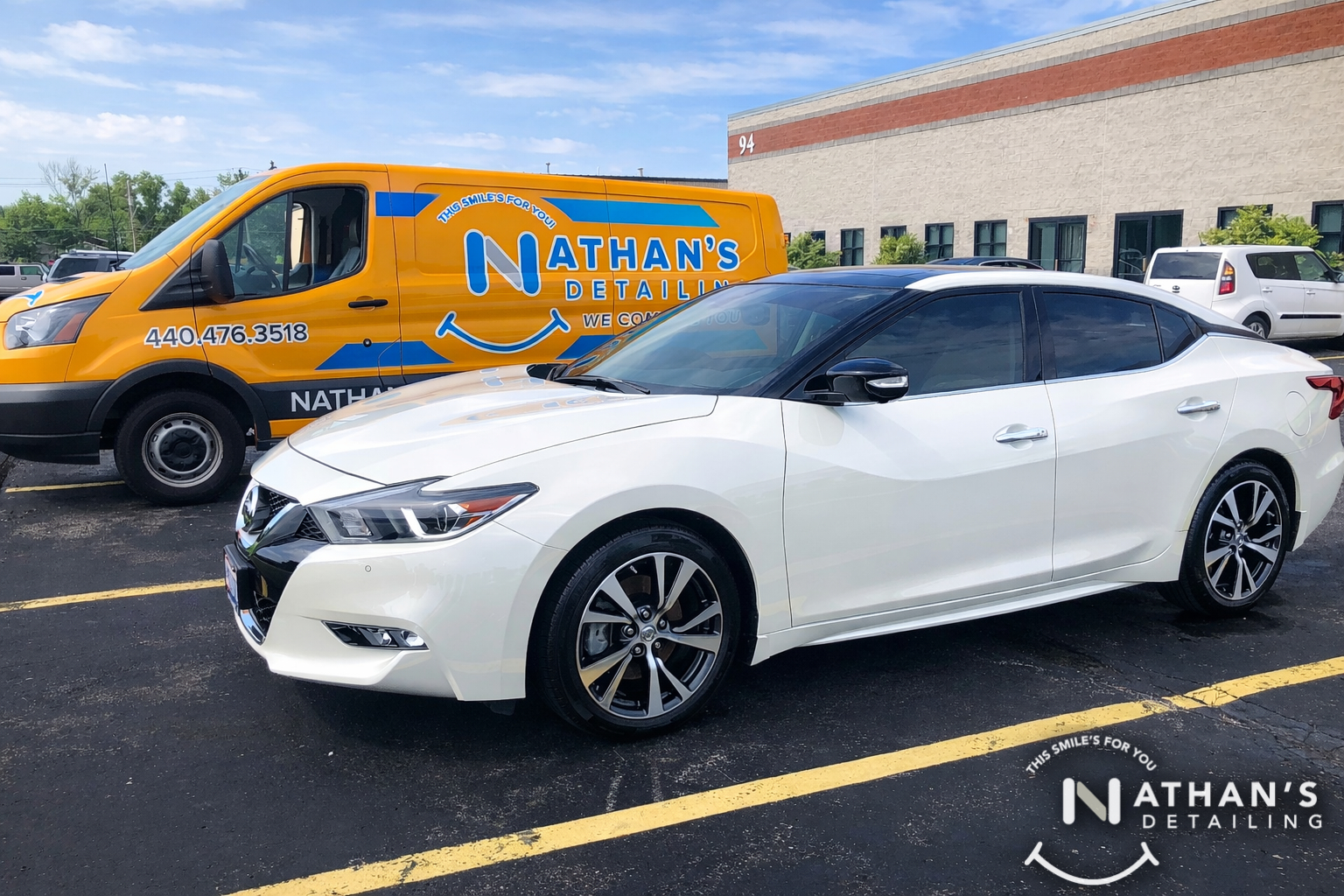 White sedan cleaned at parking lot service during mobile detailing
