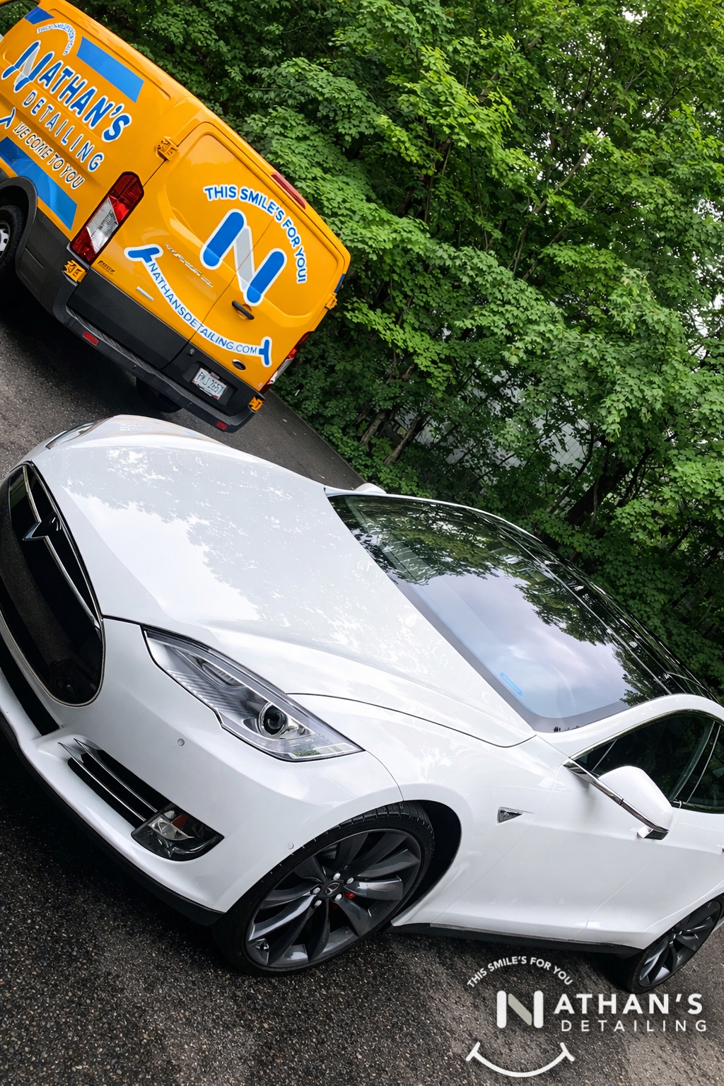 White tesla front angle with detail van during mobile detailing