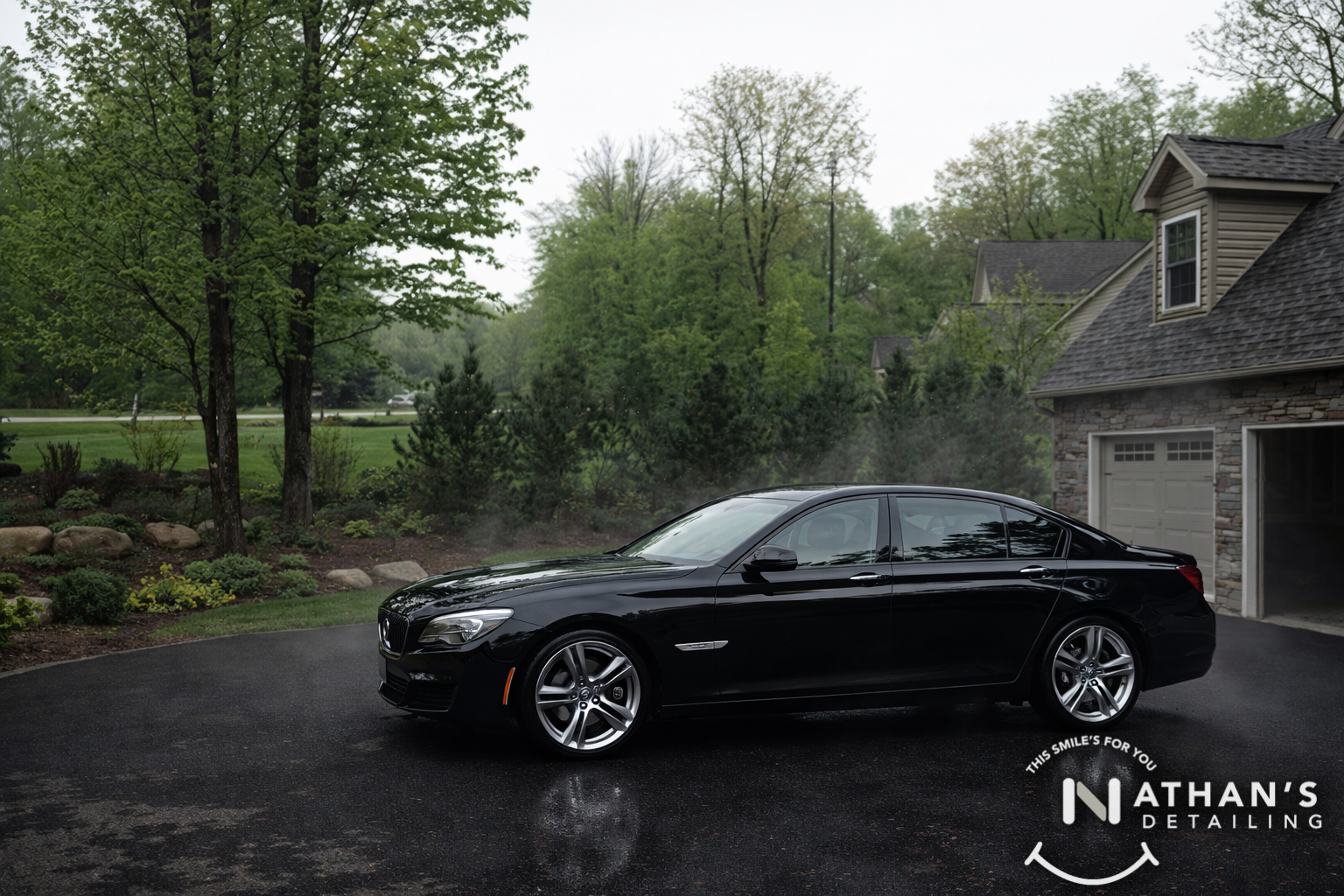 Black bmw sedan clean finish on wet driveway during mobile detailing in Pepper Pike