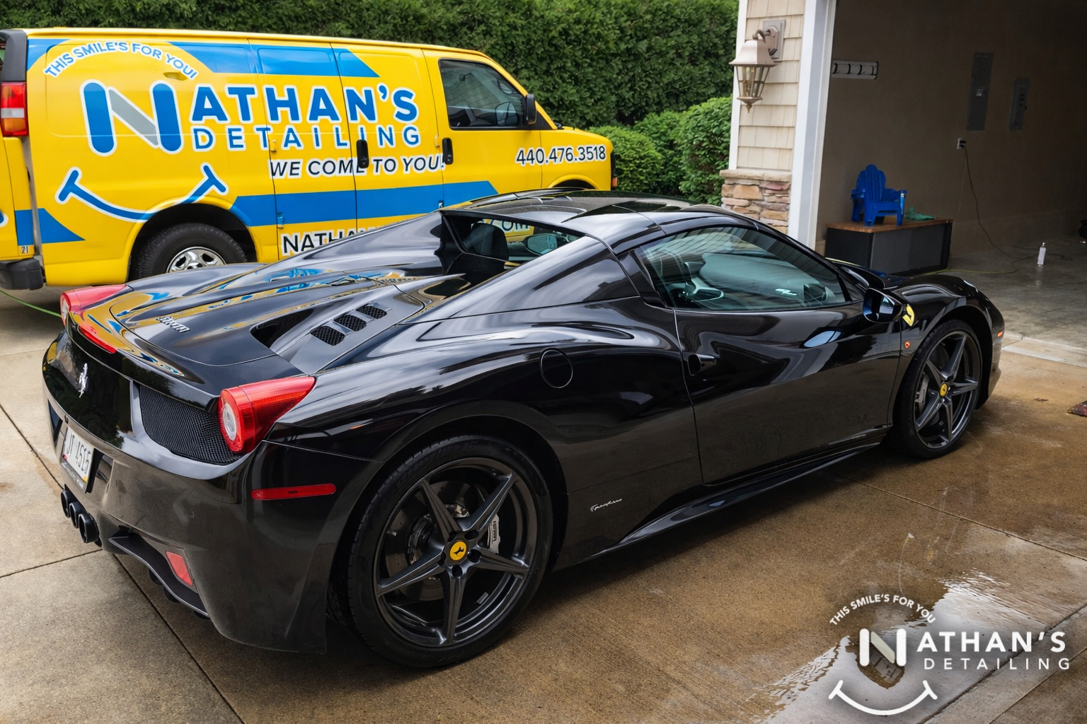 Black ferrari coupe glossy driveway during mobile detailing