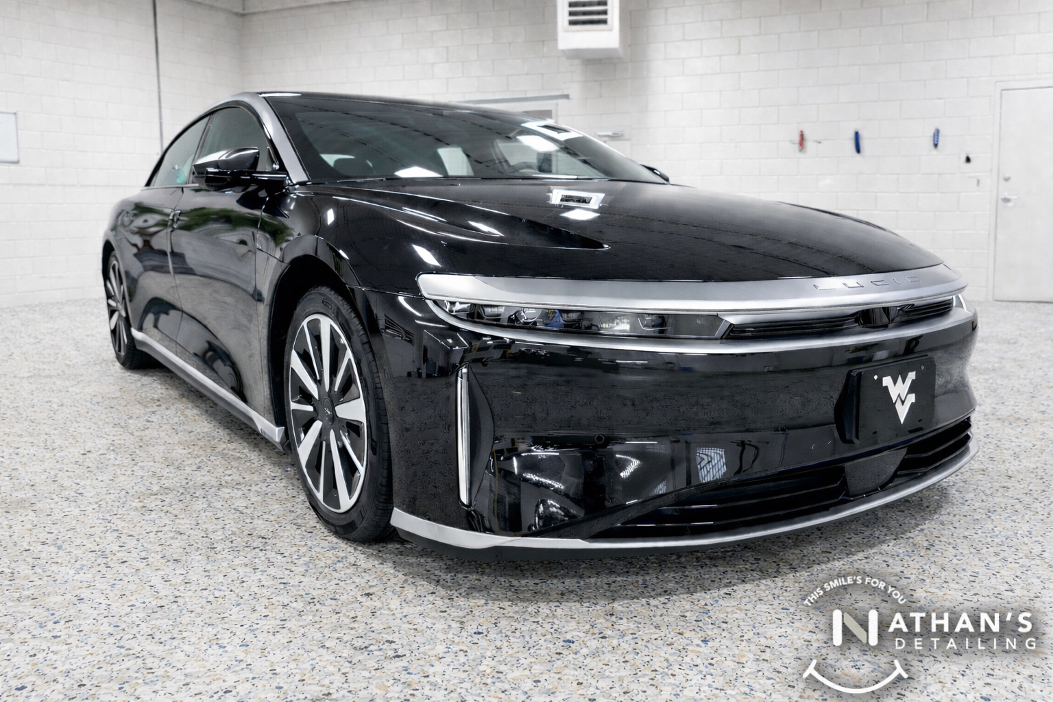 Black Lucid sedan with sharp reflections after ceramic coating service.