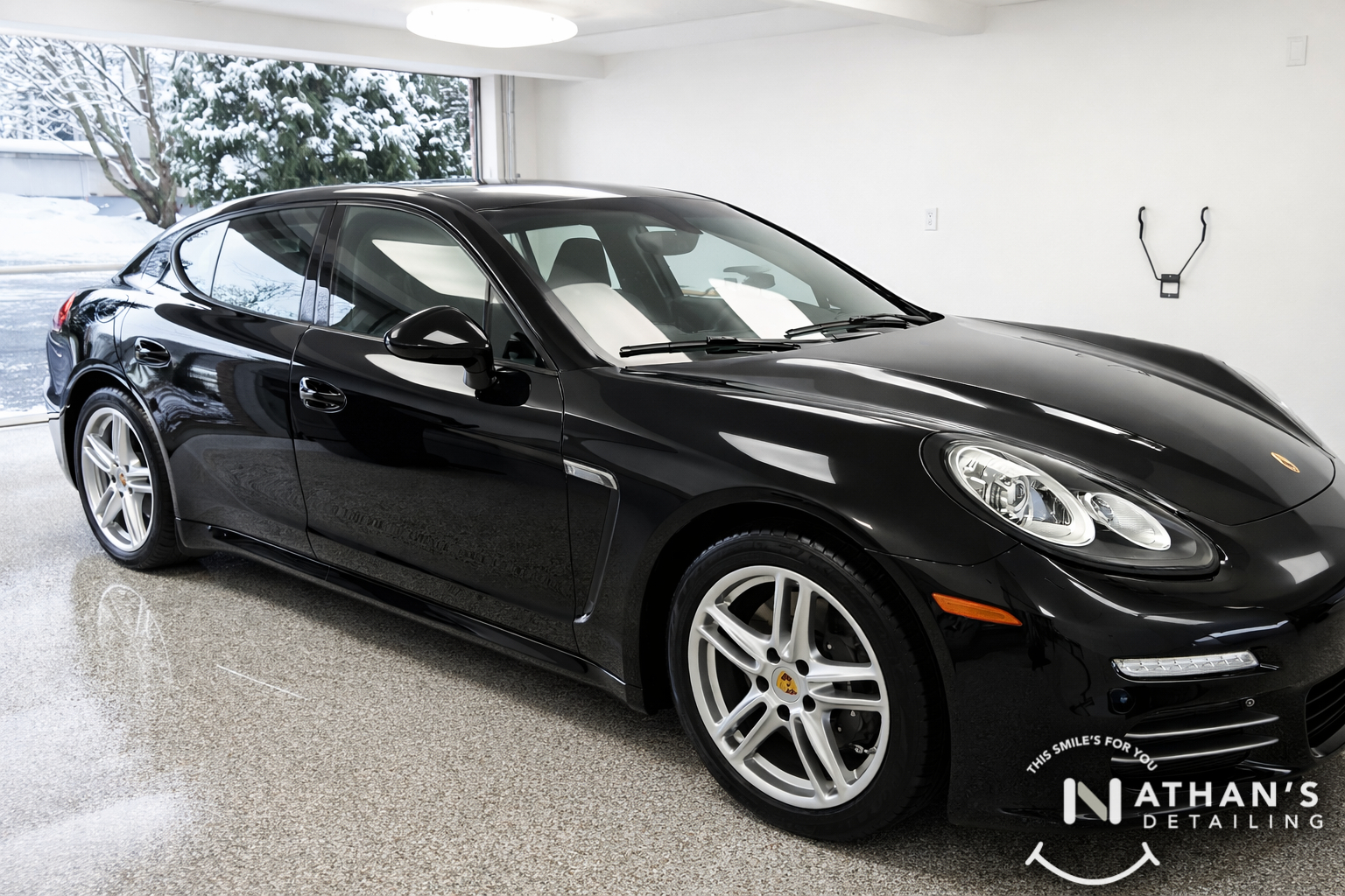 Black porsche polished finish in garage during mobile detailing