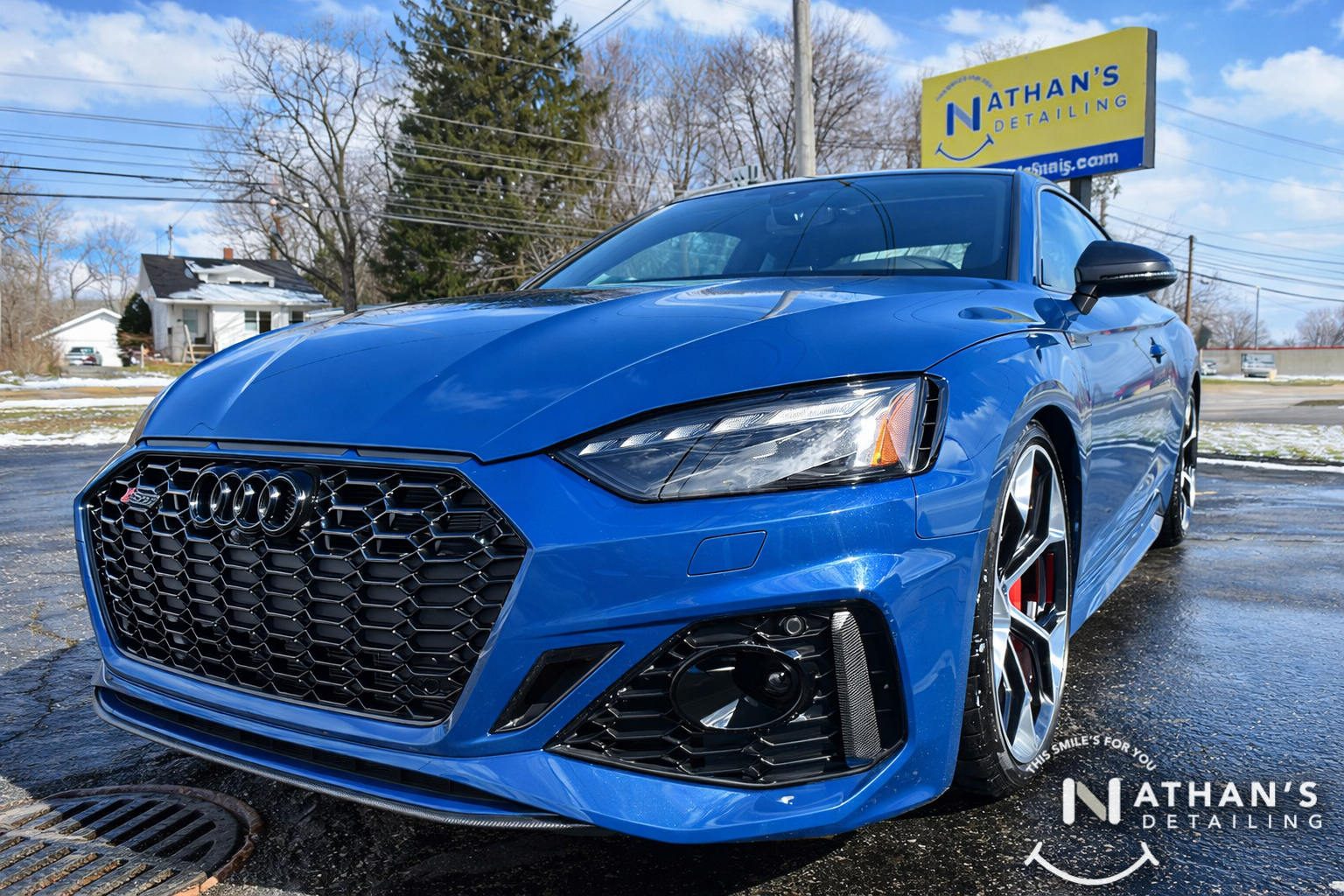 Blue Audi sedan photographed outside after paint protection film installation in Mentor, Ohio.