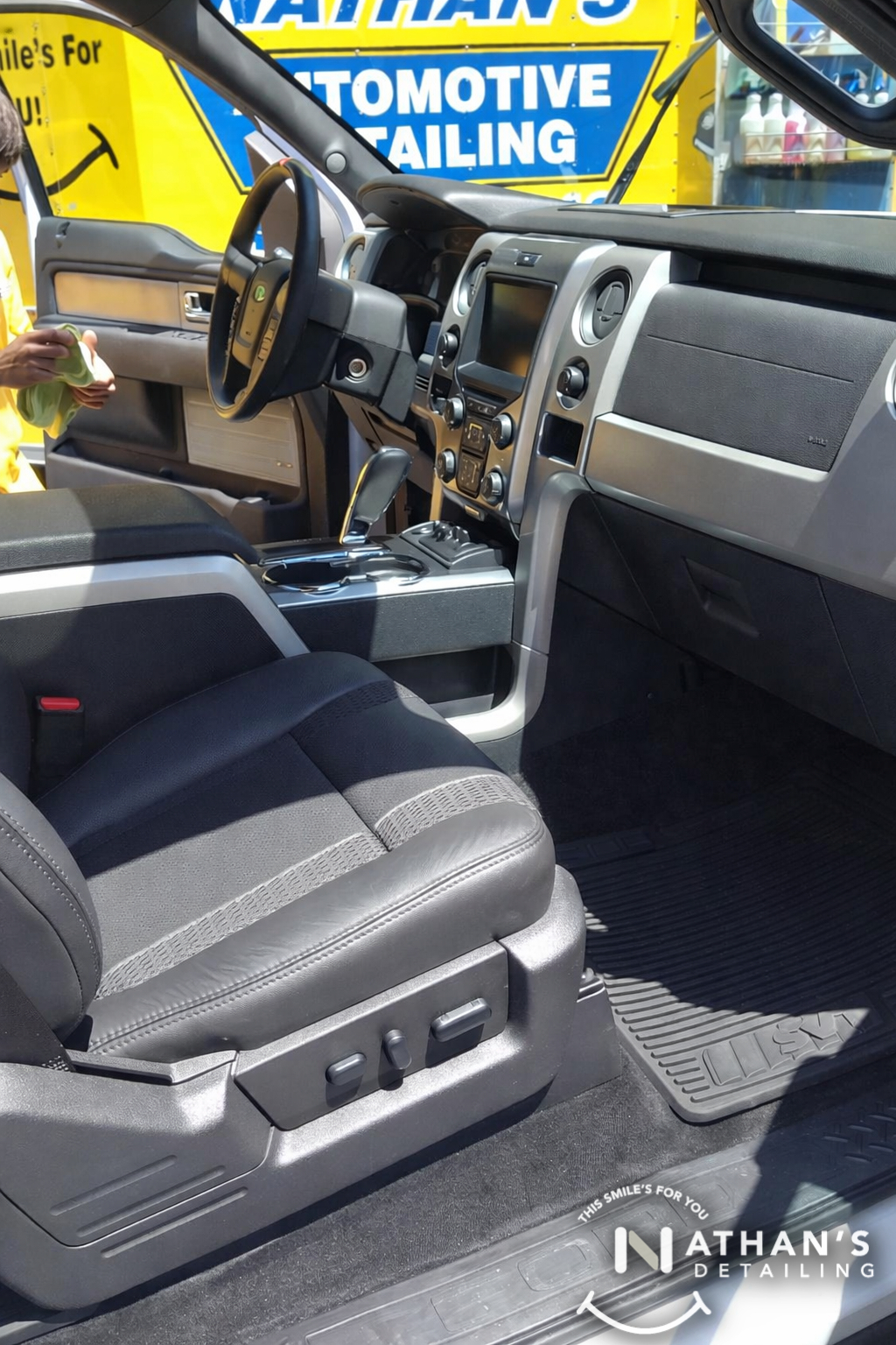 Clean front seat and center console during mobile detailing