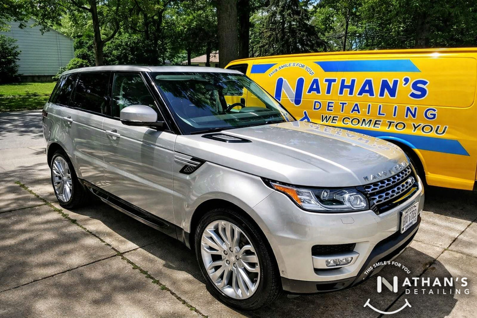 Clean silver suv parked next to detail van during mobile detailing