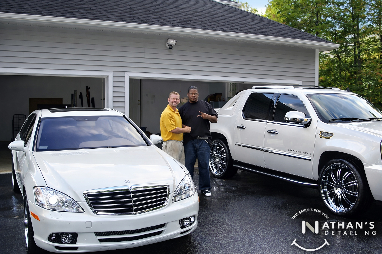 Customer and detailer with white sedan and suv during mobile detailing