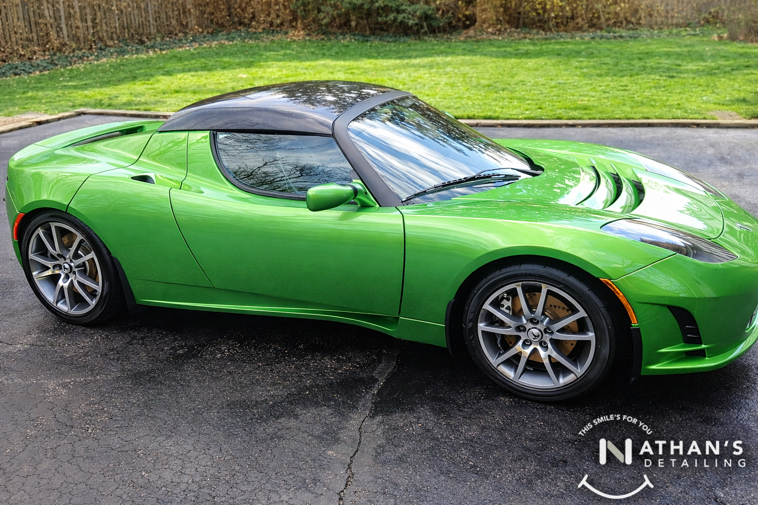 Green roadster fresh detail side view during mobile detailing