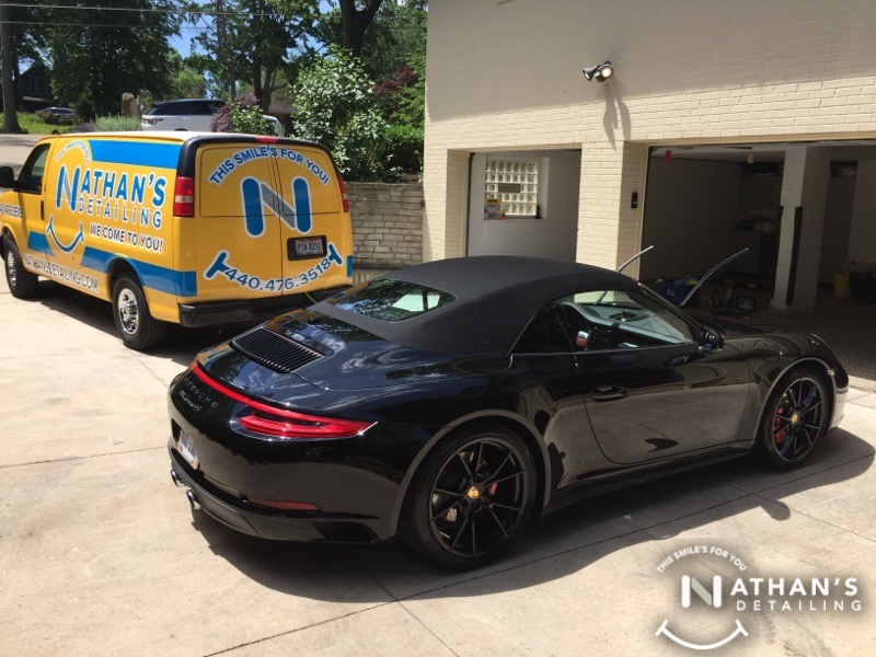 Mobile detailing van beside black convertible