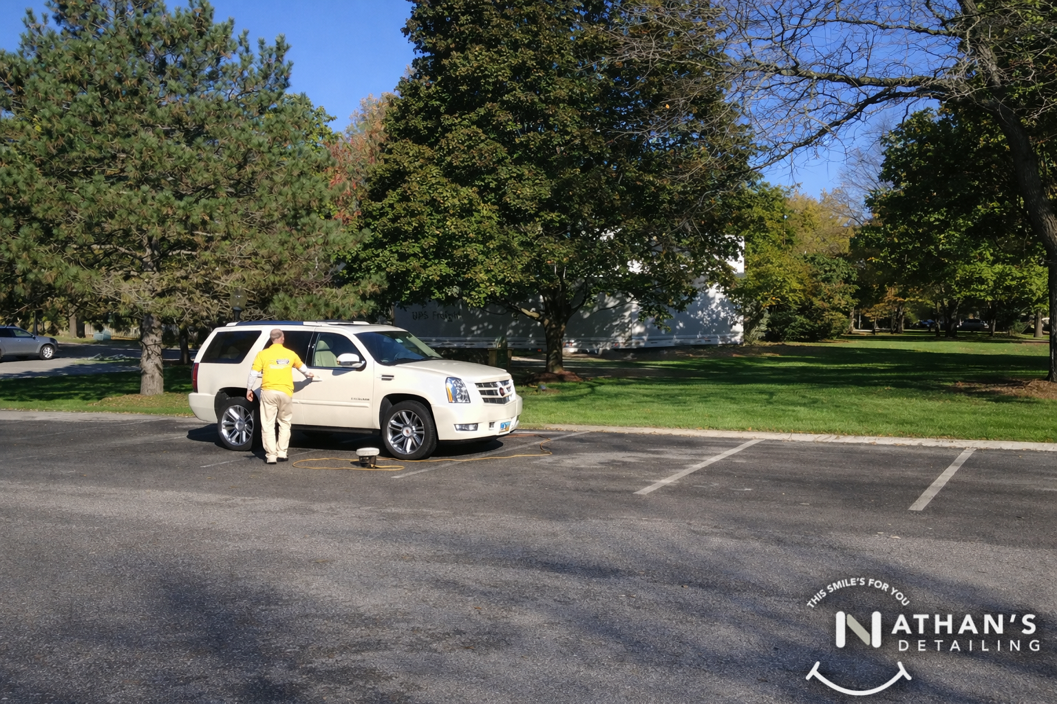On site escalade polishing in parking lot during mobile detailing