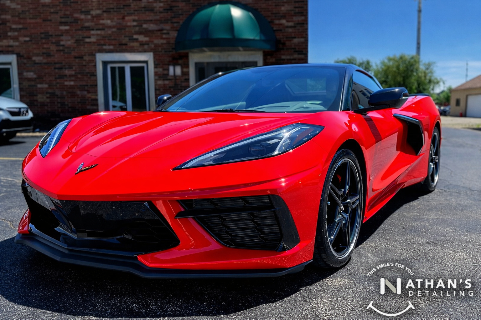 Red Corvette photographed outside after paint protection film installation.