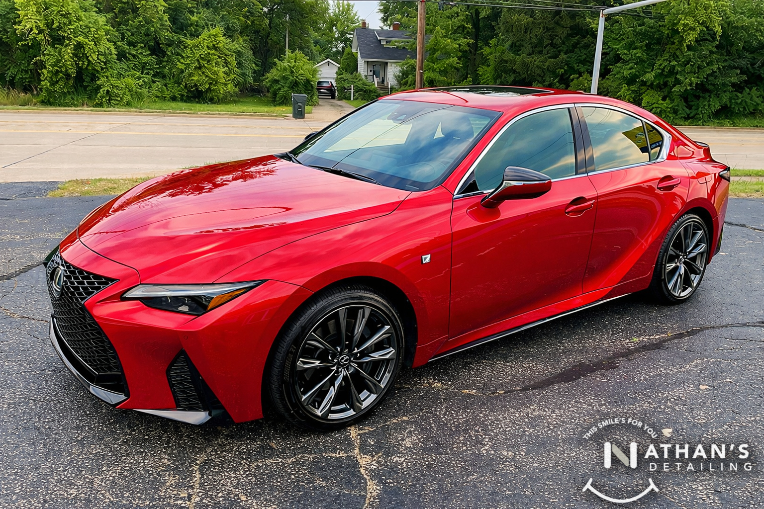Red Lexus sedan photographed outside with a glossy, paint-protected finish.